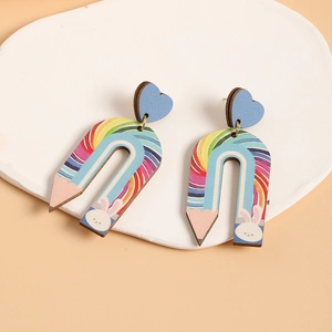 Detail of wooden U-shaped rainbow pencil earrings with cute white rabbit patterns