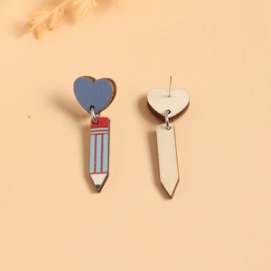 Detailed view of handmade wooden pencil and blue heart earrings with artistic print