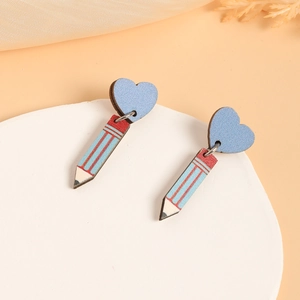 Detail view of colorful pencil and blue heart shaped wooden drop earrings for teachers