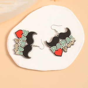 Detail of wooden mustache earrings with heart and PAPAI te amo print on stone display