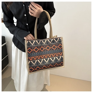 Detail of vintage geometric pattern woven tote bag with durable rope shoulder handles
