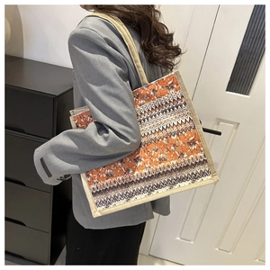 Close-up of ethnic geometric pattern tote bag with rustic jute texture straps