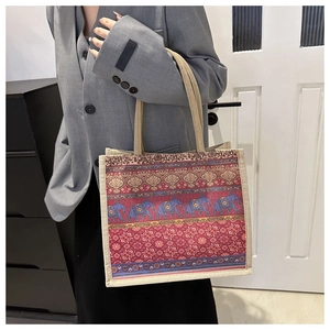 Detailed view of ethnic tote bag with blue elephant print and thick woven rope handles