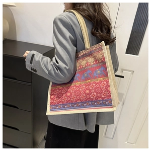 Detailed macro view of ethnic elephant prints and woven texture on a vintage tote bag