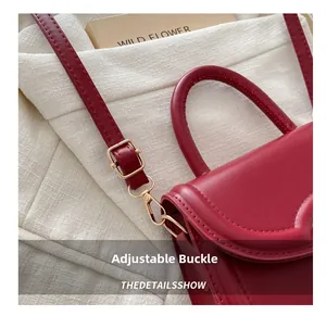 Detailed close-up of dark red leather strap with premium gold adjustment buckle and hook