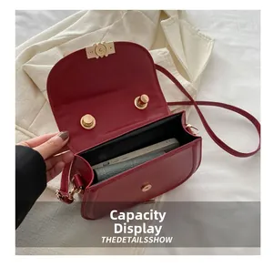 Detailed internal view showing large capacity for smartphone and wallet in red saddle bag