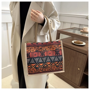 Close-up of ethnic tote bag featuring geometric tribal patterns and woven rope handles