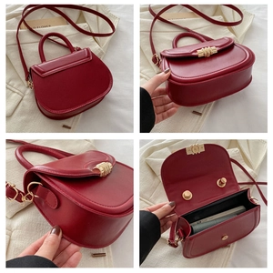 Detail view of burgundy saddle bag showing back side view and interior storage space