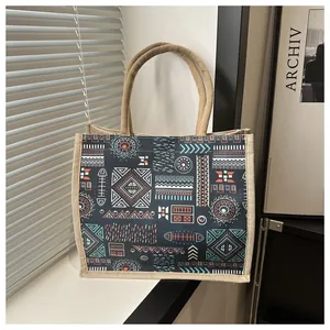 Close-up of geometric tribal patterns and texture on a linen tote bag with jute handles