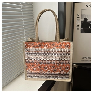 Detail shot of the jute tote bag showing wave patterns and natural woven texture