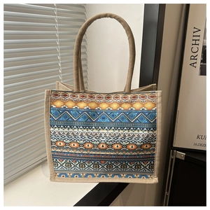 Detail of ethnic geometric pattern and woven burlap texture on large tote bag