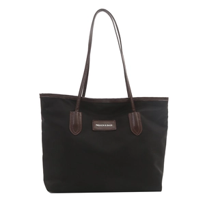 Minimalist black nylon large tote bag with brown leather handles for daily commute