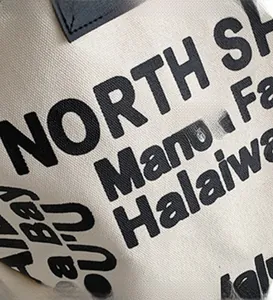 Detail of durable canvas tote bag featuring black North Shore letter printing