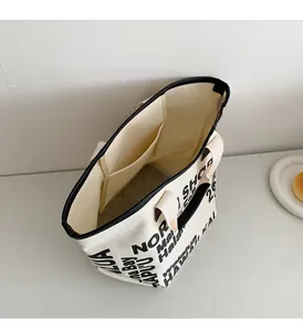 Top view showing the spacious interior and inner pocket of the canvas tote bag