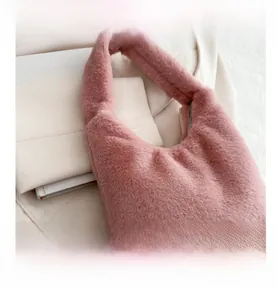Close-up of pink faux fur hobo bag with soft texture and metal zipper detail