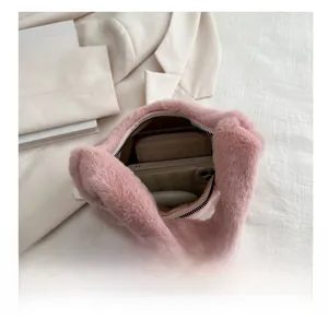 Internal view of pink plush handbag showing capacity for long wallet and smartphone