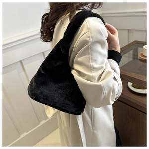 Soft black plush shoulder bag for women featuring a minimalist round design and fuzzy texture