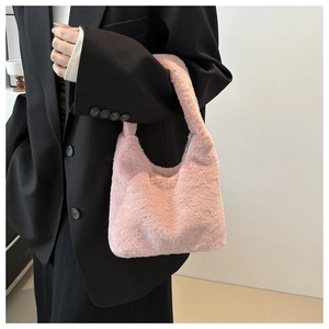 Detail of pink faux fur tote bag showing soft plush texture and elegant hobo design
