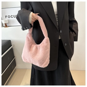Detail of pink faux fur crescent handbag showing soft plush texture and trendy half-moon shape