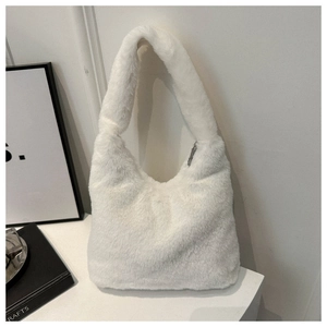 Detail of white faux fur hobo bag showing soft fluffy texture and silver zipper closure