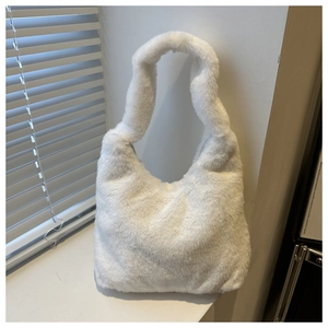 Detail shot of a white faux fur shoulder bag on a windowsill with natural light