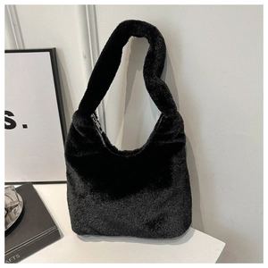 Detailed macro view of soft black faux fur texture and silver zipper on hobo bag