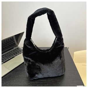 Close-up of fluffy black faux fur tote bag texture and integrated plush handle detail