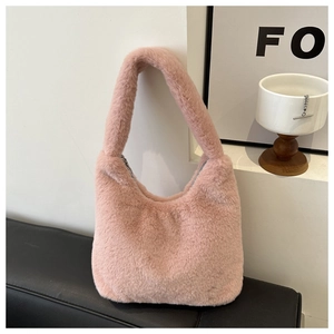 Detail of pink faux fur shoulder bag with soft plush texture and zipper closure