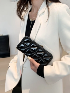Elegant black quilted long wallet for women with high-gloss finish and golden zipper closure