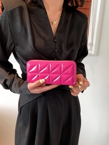 Quilted rose pink leather clutch wallet with geometric patterns and gold zipper closure