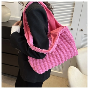 Close-up of bright pink textured bubble fabric on a large tote bag for women