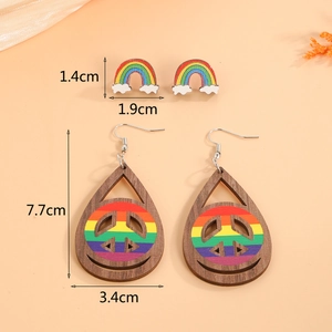 Detailed view of rainbow peace sign wooden drop earrings and cloud stud earring set