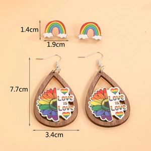 Detailed size view of wooden Pride earrings with Love is Love slogan and rainbow prints