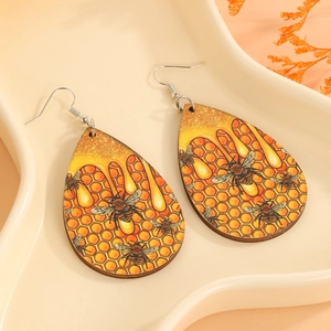 Bohemian teardrop wooden earrings featuring artistic bee and honeycomb print patterns