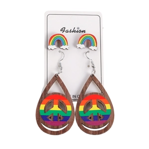 Rainbow themed earring set with wooden peace sign drops and cloud studs on card