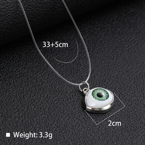 Detail of evil eye pendant with green iris and transparent fishing line chain dimensions