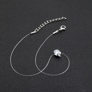 Detail of tear-drop cubic zirconia pendant on invisible transparent fishing line chain