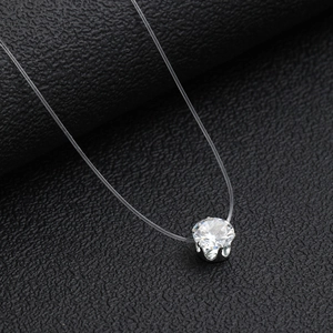 Minimalist transparent fishline necklace with heart-shaped cubic zirconia pendant