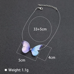 Macro detail of purple tulle butterfly pendant with transparent fishline necklace chain
