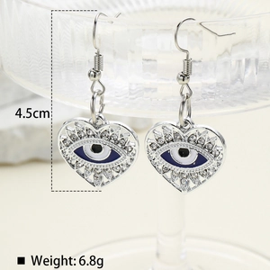 Macro shot of silver heart evil eye earrings with sparkling rhinestones, 4.5cm length