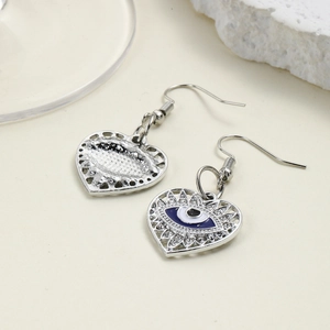 Retro heart-shaped evil eye drop earrings with blue enamel in polished silver finish