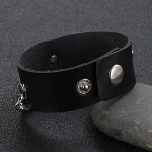 Punk style wide black leather bracelet with silver shield buckle and side chain detail