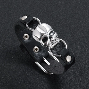 Detailed macro view of leather skull bracelet with silver rivets and buckle closure