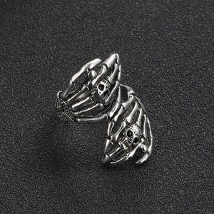 Retro punk gothic ring featuring dual skull hands design in oxidized silver finish
