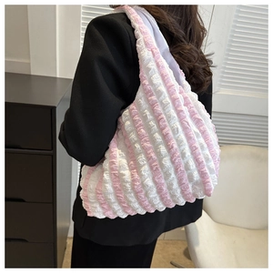 Detail view of pink and white striped bubble tote bag showing large capacity and puffy texture
