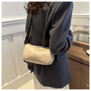 Détail du sac à bandoulière rectangulaire blanc cassé avec sangle jacquard sur modèle