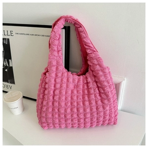 Detail of pink bubble texture fabric on a large capacity minimalist shoulder tote bag