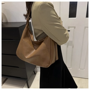 Deep brown oversized Hobo bag worn with beige suit for stylish office commute look