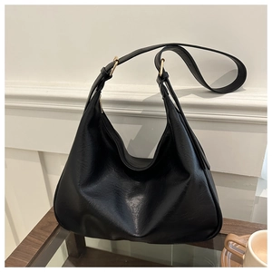 Close-up of black PU leather shoulder bag featuring smooth zipper and gold hardware