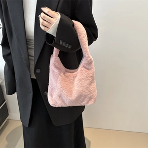 Pink plush hobo handbag made of soft faux fur with minimalist design for winter